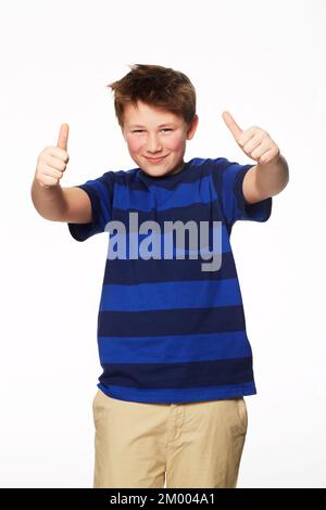 You get two thumbs up. Portrait of a young boy giving you two thumbs up. Stock Photo