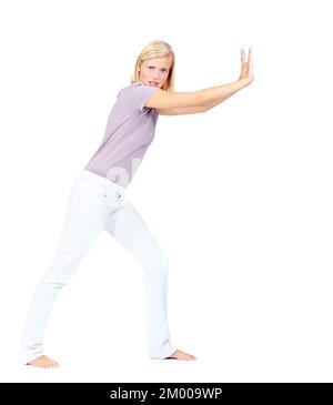 This wont budge. Pretty young woman pushing a object to the right - Isolated on white. Stock Photo