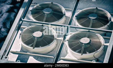 air conditioner heat pump white fans vent rooftop splitters rotating background Stock Photo