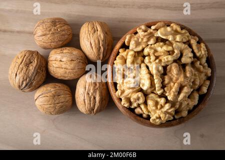A bowl of peeled walnuts and a group of shelled walnuts Stock Photo