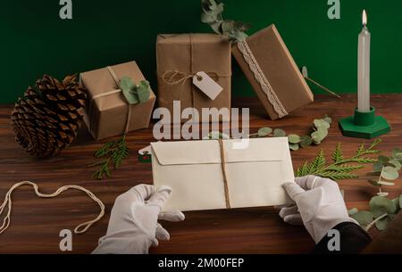 Human hands with gloves and a beige textured envelope. Stock Photo