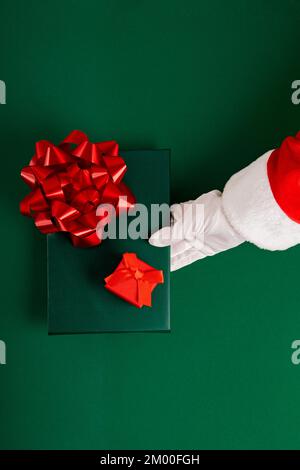 Cropped Santa Claus Hands Holding Christmas Gifts Stock Photo