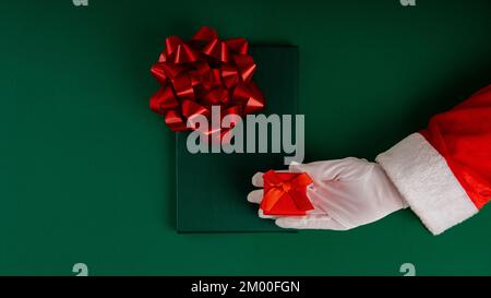 Cropped Santa Claus Hands Holding Christmas Gift Stock Photo