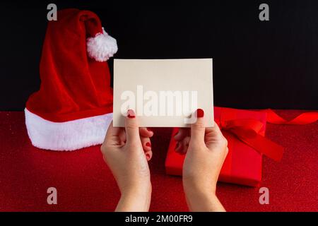 Post card mock up with woman's hand and christmas background Stock Photo