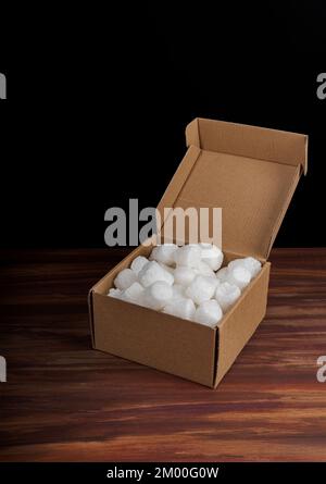 Brown kraft cardboard box with biodegradable peanuts packaging Stock Photo