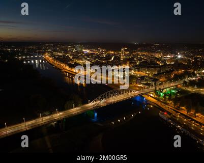 Arnhem city in the Netherlands by night Aerial drone. City center, rhine river and church, Eusebiuskerk, john frost bridge, skyline and infrastructure Stock Photo