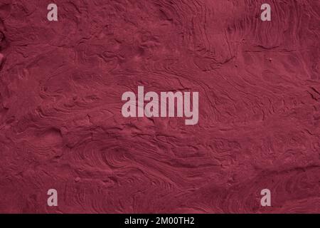 Viva Magenta toned colored grunge. Rough texture of natural stone, toned banner trendy color 2023. Grunge Viva Magenta color texture. Stock Photo