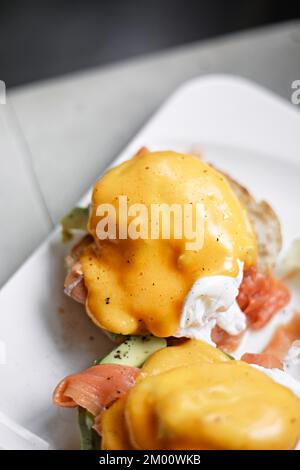 Egg benedict with avocado and smoked salmon Stock Photo