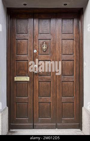 Image of Wooden vintage entrance door with handle knocker and handle Stock Photo