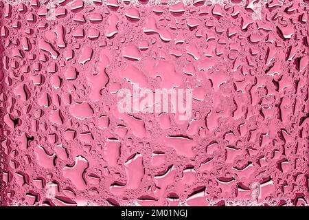 Rain drops on wet transparent glass, abstract background, trendy Magenta color, copy space Stock Photo
