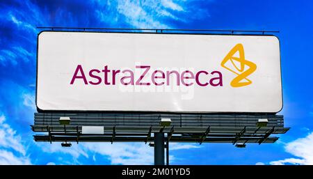 POZNAN, POL - OCT 28, 2022: Advertisement billboard displaying logo of AstraZeneca, a pharmaceutical and biotechnology company headquartered in Cambri Stock Photo