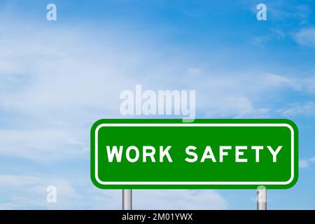 Green color transportation sign with word work safety on blue sky with white cloud background Stock Photo