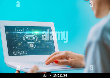 Woman using a chatbot on her laptop Stock Photo