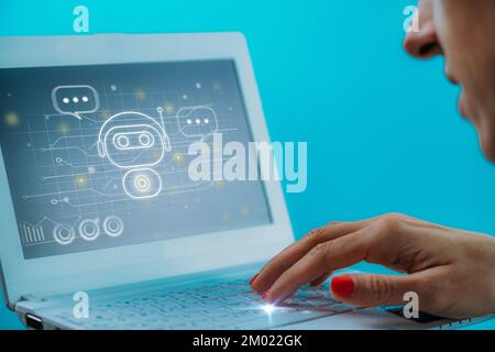 Woman using a chatbot on her laptop Stock Photo
