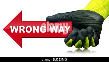 Hand with protective work glove, holding a Wrong Way Road Sign, English language, isolated on white background, photography, red arrow. Stock Photo