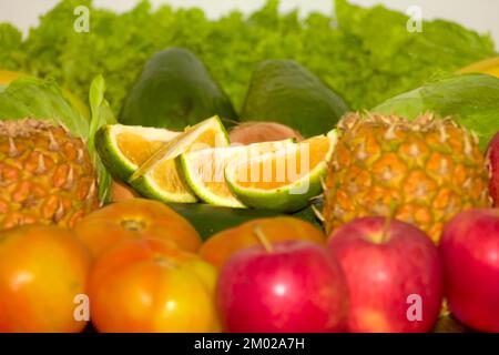 Variety of fruits and vegetables grouped as banana, cucumber, apple, pineapple, lettuce, tomato, orange and more Stock Photo