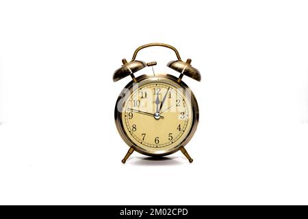 Old alarm clock in metal case on white background. Stock Photo