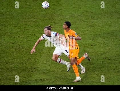 USA's Walker Zimmerman (left) and Netherlands' Cody Gakpo battle for the ball during the FIFA World Cup round of 16 match at the Khalifa International Stadium in Al Rayyan, Qatar. Picture date: Saturday December 3, 2022. Stock Photo