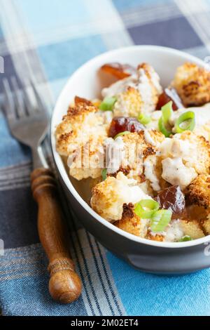 Roasted Cauliflower with Dates and Tahini Dressing Stock Photo