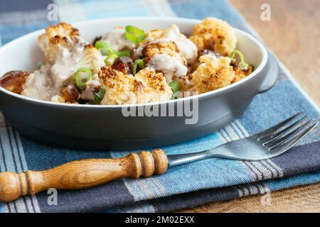 Roasted Cauliflower with Dates and Tahini Dressing Stock Photo