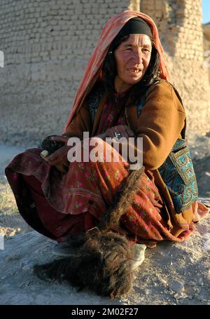 Dowlat Yar, Ghor Province / Afghanistan: Portrait of a woman in central Afghanistan. She has traditional facial tattoos (blue ink dots). Stock Photo