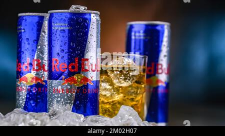 POZNAN, POL - NOV 25, 2022: Cans of Red Bull, an energy drink sold by Red Bull GmbH, an Austrian company created in 1987 Stock Photo