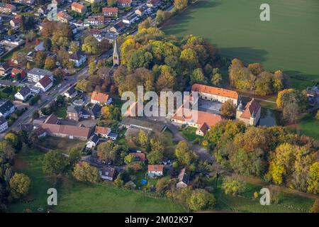 Aerial view, Heeren castle, evang. church Heeren, autumn colors, Heeren-Werve, Kamen, Ruhr area, North Rhine-Westphalia, Germany, Worship site, Colorf Stock Photo