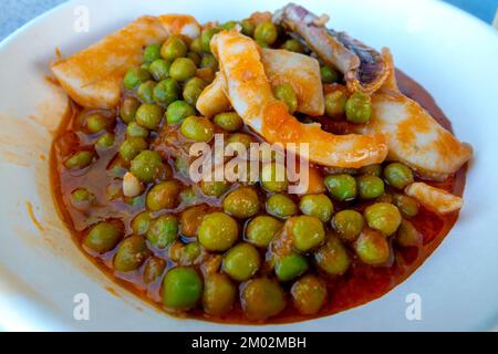 Cuttlefish with peas in tomato sauce Stock Photo