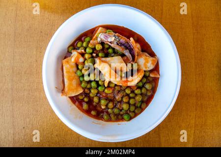 Cuttlefish with peas in tomato sauce Stock Photo