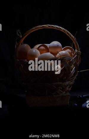 Fresh eggs from organic farms are placed in a wicker basket Stock Photo