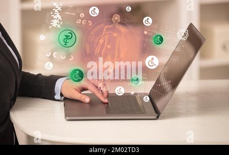 Doctor working on laptop with healthcare concept Stock Photo