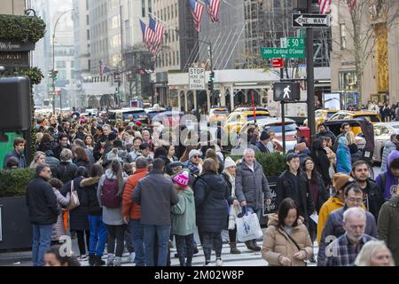 Black Friday crowds on 5th Avenue and 50th Street at Rockefeller Center mark the traditional beginning of the holiday shopping season in New York City. Stock Photo