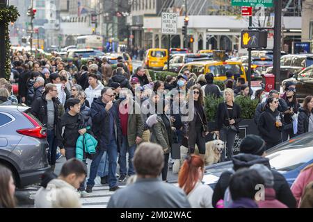 Black Friday crowds on 5th Avenue and 50th Street at Rockefeller Center mark the traditional beginning of the holiday shopping season in New York City. Stock Photo