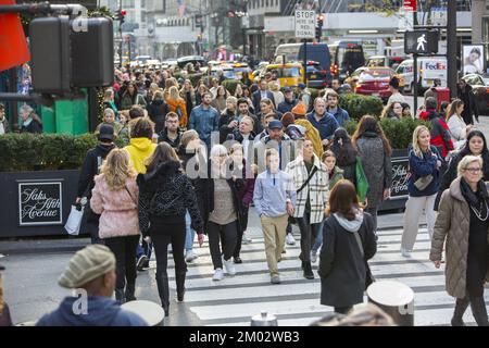 Black Friday crowds on 5th Avenue and 50th Street at Rockefeller Center mark the traditional beginning of the holiday shopping season in New York City. Stock Photo