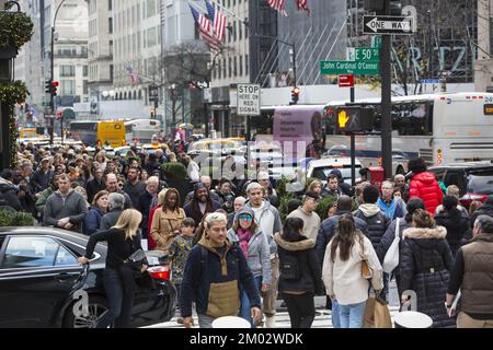 Black Friday crowds on 5th Avenue and 50th Street at Rockefeller Center mark the traditional beginning of the holiday shopping season in New York City. Stock Photo