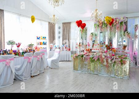 The banquet hall in the restaurant is prepared for the wedding celebration. Stock Photo