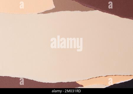 Abstract beige brown colors background. Grunge ripped torn paper pieces with ragged edges. Top view, copy space Stock Photo