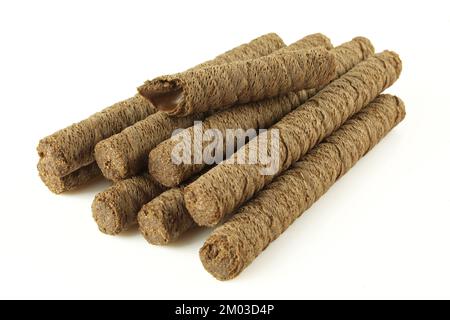 Pile of wafer roll sticks filled with chocolate isolated on white background Stock Photo