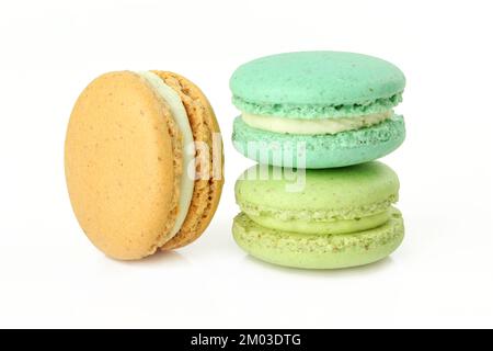 Three different colour macaroons isolated on white background. French delicacy cream cookies Stock Photo
