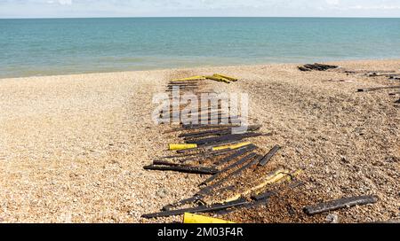 Hastings, united kingdom, 24, August 2022, wooden slipway on a pebble beach for boats, showing the pollution from oil Stock Photo