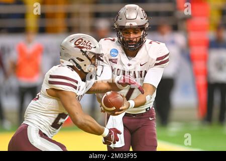 Montana Grizzlies quarterback Lucas Johnson (7) hands off to Montana Grizzlies running back Isiah Childs (28) a NCAA FCS second round playoff game between the University of Montana Grizzlies and the North Dakota State Bison at the Fargo Dome, Fargo, ND on Saturday, December 3, 2022. NDSU leads 21-13 at halftime. Russell Hons/CSM Stock Photo