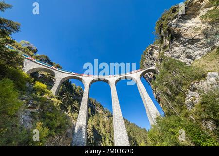 Swiss train over Landwasser Viaduct bridge in the alps, Graubunden, Switzerland Stock Photo