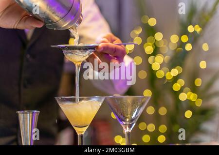 Closeup elegant cocktail in night club on bar counter with lights at nightclub party. Stock Photo