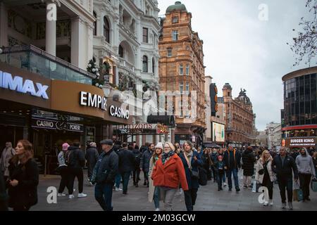 London, December 3rd 2022 - Passers by at Leicester Square Christmas Market Stock Photo