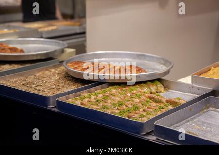 Picture of baklava for sale in a shop in the city center of Istanbul, Turkey. Baklava is a layered pastry dessert made of filo pastry, filled with cho Stock Photo