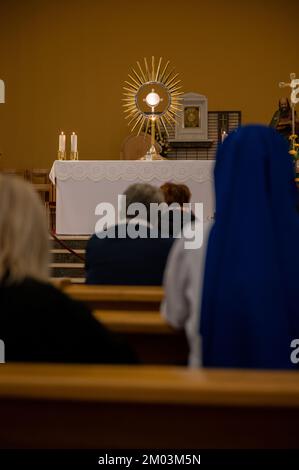 Adoration of Jesus Christ present in the Blessed Sacrament in St James Church in Medjugorje. Stock Photo