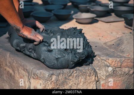 Midsection of professional potter working with clay on the square in Kathmandu, Nepal Stock Photo