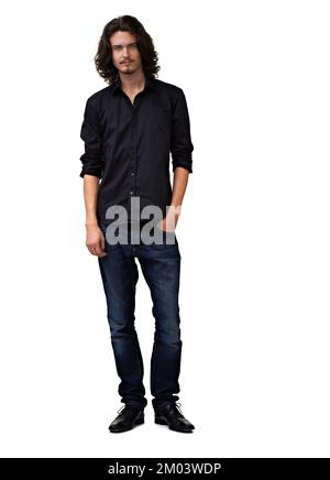 Cool and collected. Handsome young man standing with her hand in his pocket - full length. Stock Photo