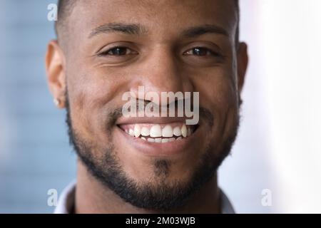 Happy attractive young African guy face close up portrait Stock Photo