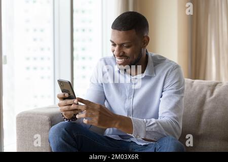 Happy African guy talking on video call on smartphone Stock Photo